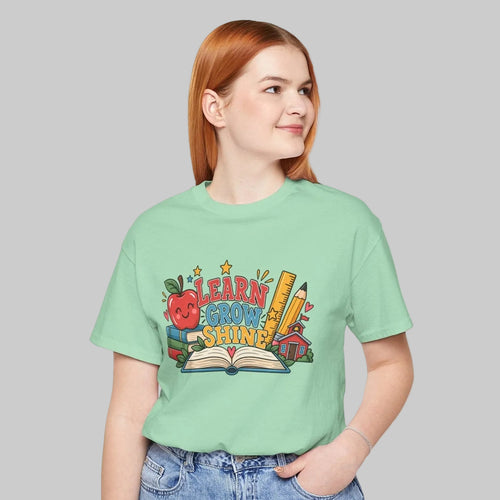 Learn Grow Shine teacher shirt with books, apple and schoolhouse graphic